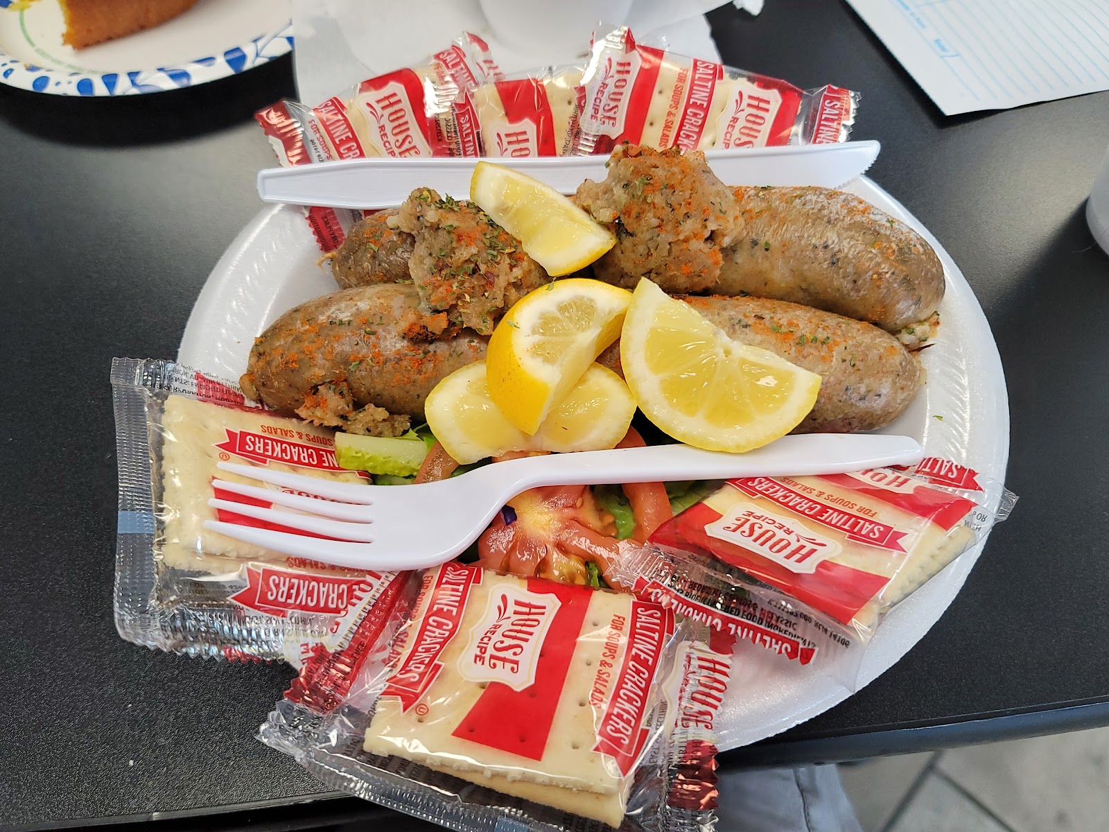 Stuffed seafood sausage plate with lemon at Bayseas Restaurant